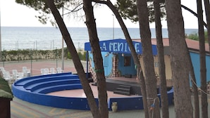 A stage area with a blue backdrop and a sign reading "LA FENICE".