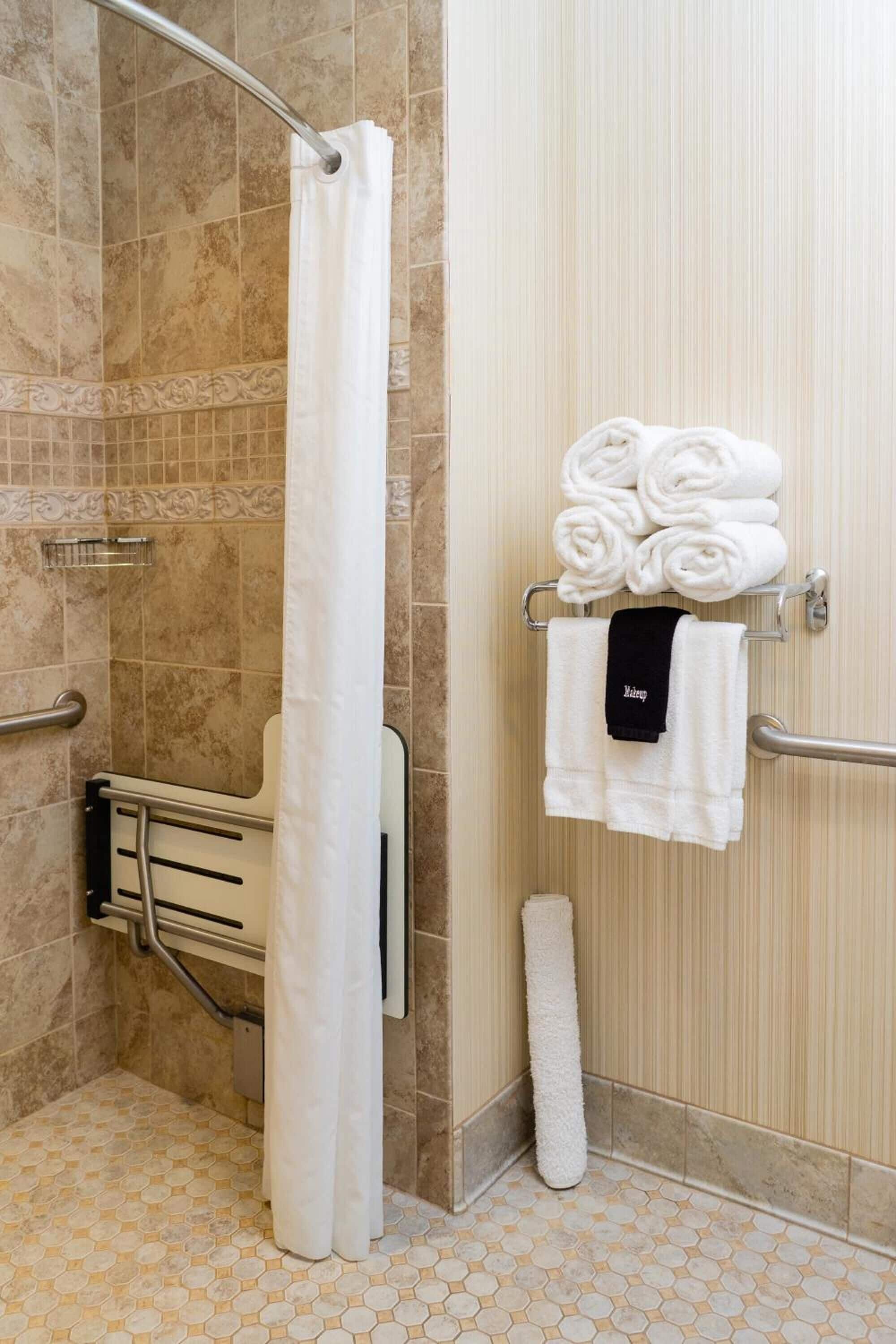 shower, designer toiletries, hair dryer, towels