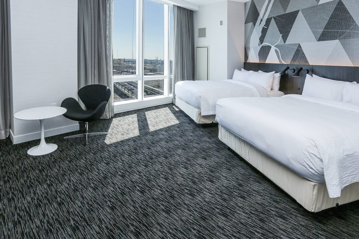 family room, 2 queen beds, corner | in-room safe, desk, iron/ironing board, free cots/infant beds