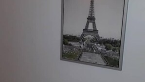 A framed picture of the Eiffel Tower on a white wall. - Swisscottage suites (Lagos)