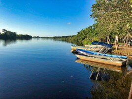 A calm river with boats docked on the right.