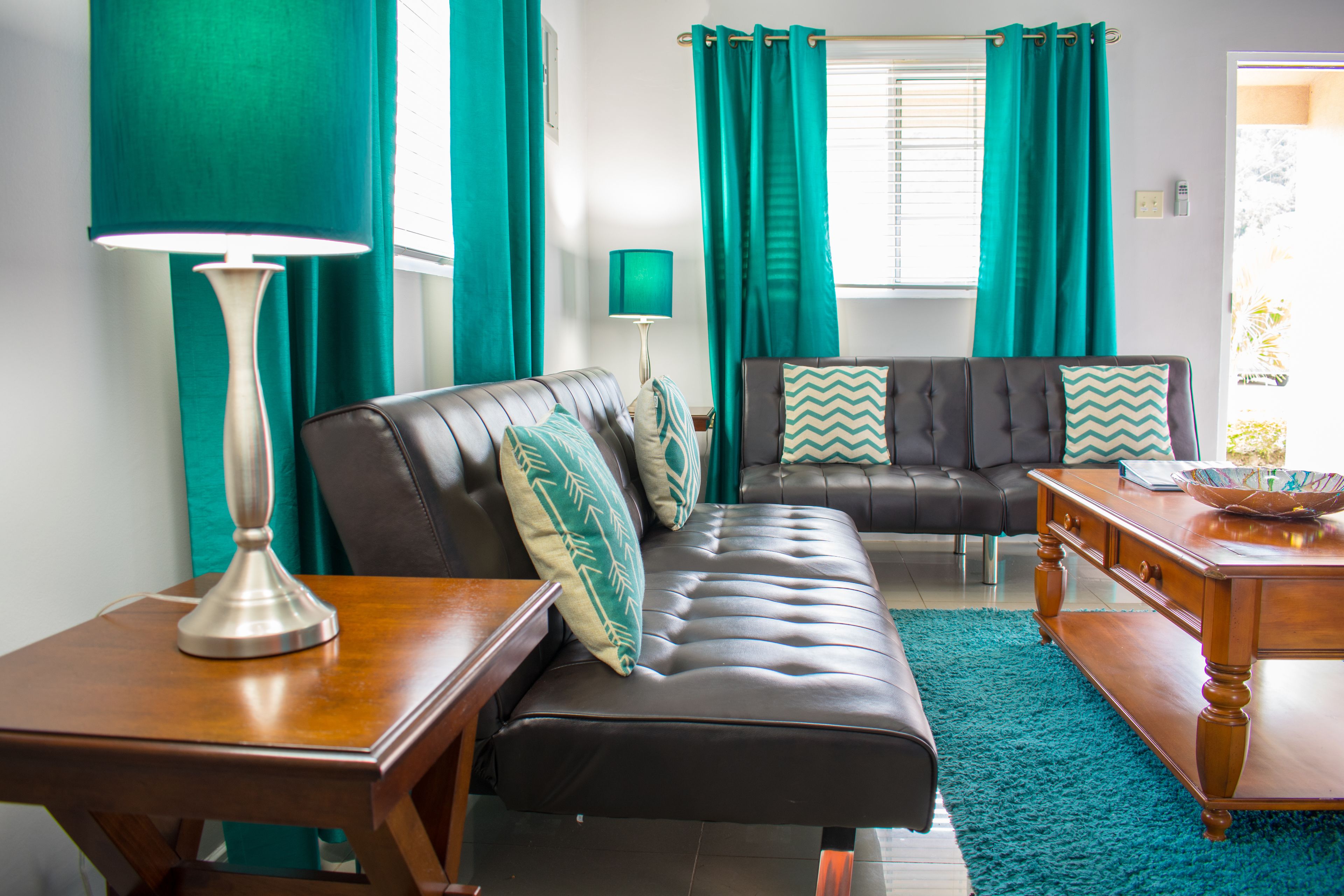 A living room with a sofa, a coffee table, and a lamp.
