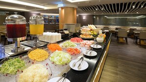 A buffet with various food items and beverages, including fruits, vegetables, and a drink dispenser. - Shiny Ocean Hotel (Hualien City)