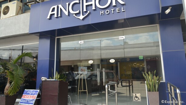 The exterior of the Anchor Hotel with a clear sign, a pull-up sign, and a disabled parking sign. - Anchor Hotel (General Santos)