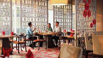 A restaurant with a traditional Asian design, featuring patterned screens and red decorations.