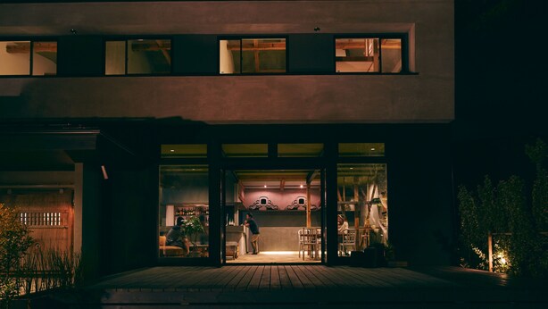 A modern two-story building with a glass entrance and a wooden deck. - Kagelow Mt Fuji Hostel Kawaguchiko (Fujikawaguchiko)