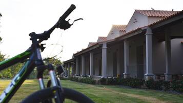 A bicycle in the foreground with a house in the background.