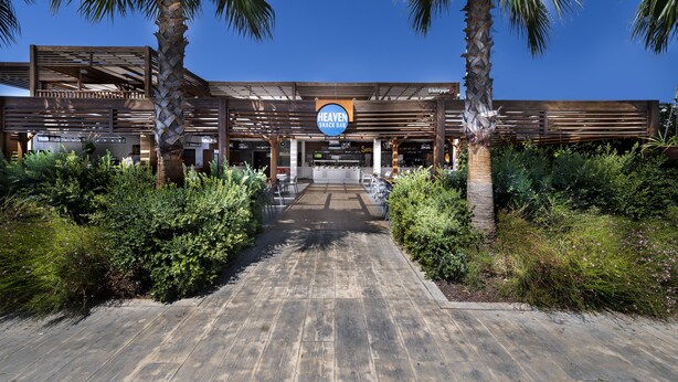 A modern building with a sign for 'Heaven Snack Bar' at the entrance. - Adalya Elite Lara Hotel - All Inclusive (Antalya)