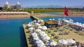 A waterfront resort with a pier, beach, and pool area. - Adalya Elite Lara Hotel - All Inclusive (Antalya)