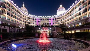 A hotel with a large central fountain, multiple balconies, and two prominent domed structures. - Adalya Elite Lara Hotel - All Inclusive (Antalya)