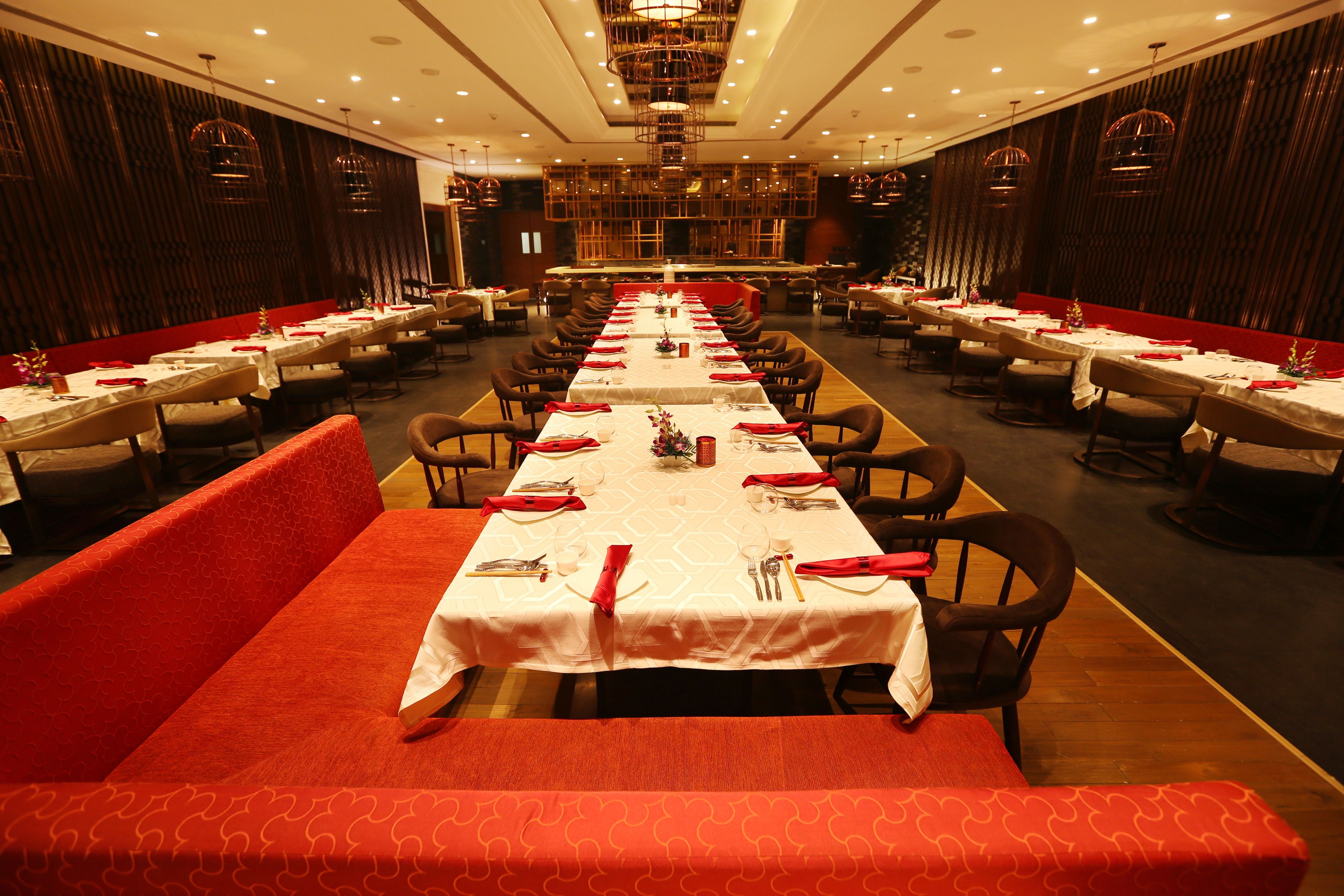 A large dining hall with multiple tables and booths, arranged in a symmetrical layout.