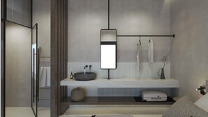 A modern bathroom with a built-in sink, a towel rack, and a mirror. - Le Palme (Hersonissos)