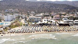 A coastal town with a beach crowded with umbrellas and sun loungers. - Malliotakis Beach Hotel by Checkin (Hersonissos)