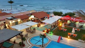A resort with a pool, outdoor seating, and a view of the ocean. - Malliotakis Beach Hotel by Checkin (Hersonissos)