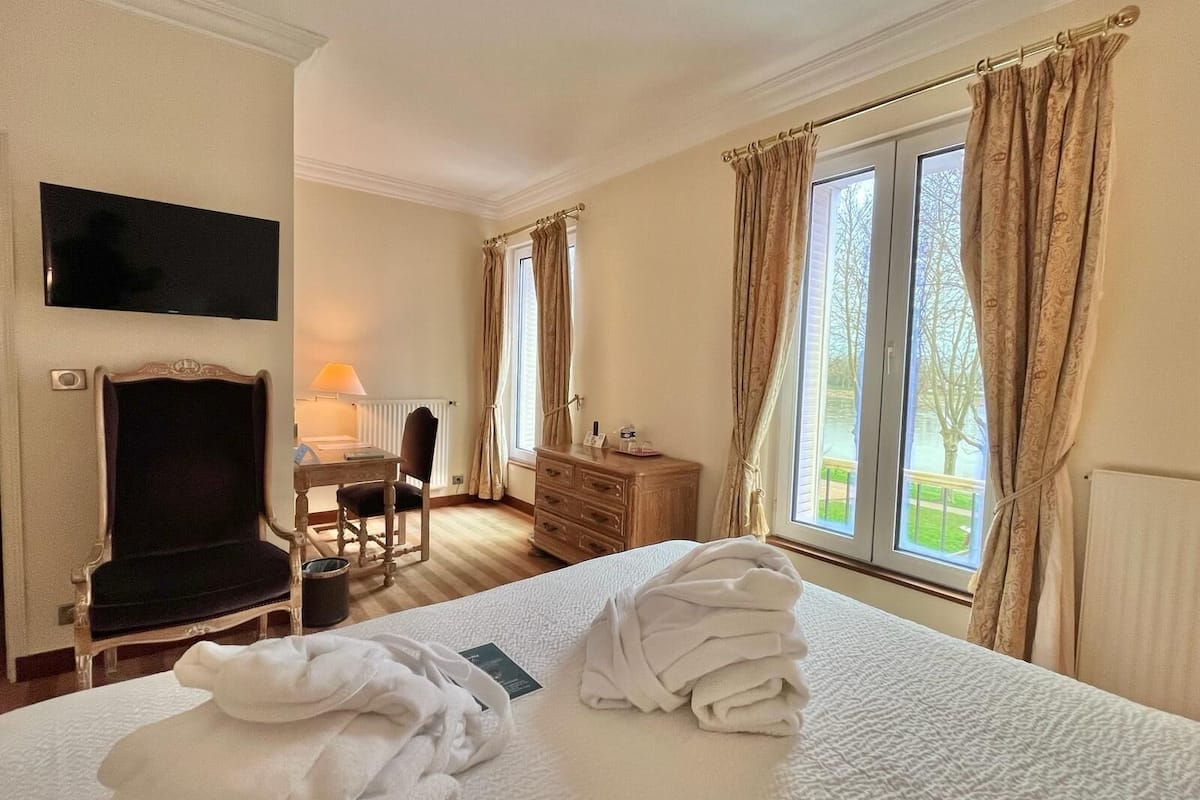 classic suite, 1 bedroom, bathtub, river view | premium bedding, in-room safe, individually decorated, desk