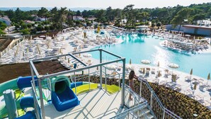 A large outdoor swimming pool with multiple lounge areas and a water slide. - Zaton Holiday Resort Camping homes (Nin)