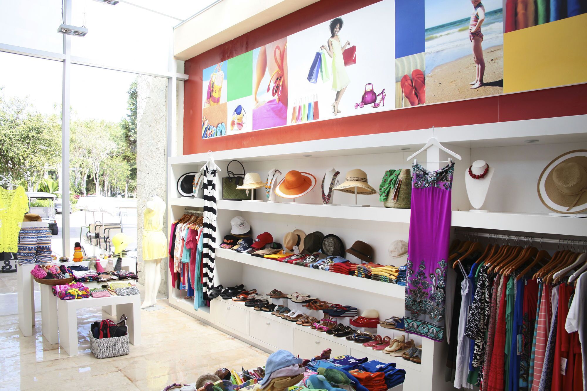 A boutique with shelves of hats, bags, and clothing.