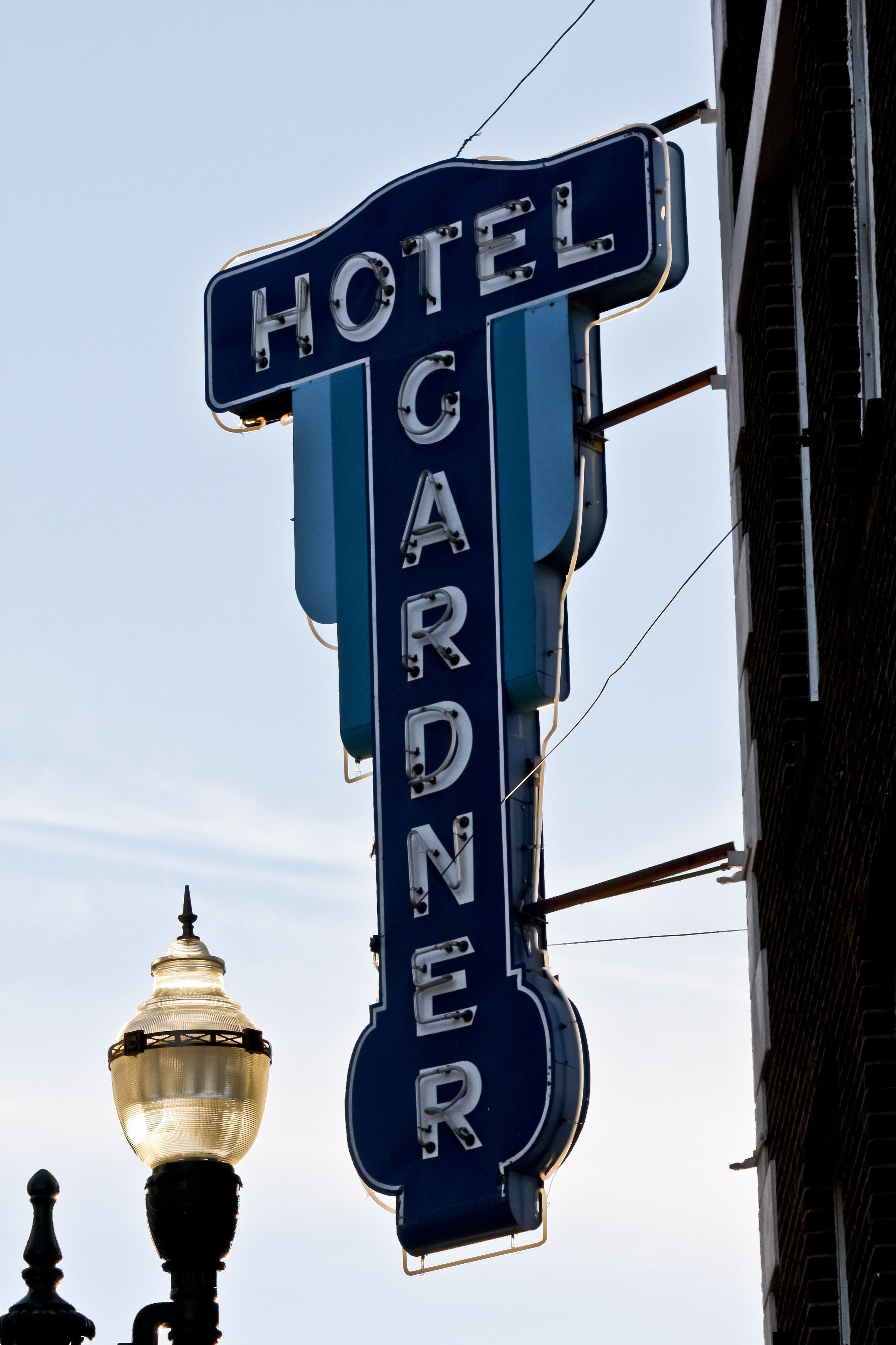A vintage hotel sign with the name "HOTEL CARDNER" prominently displayed.