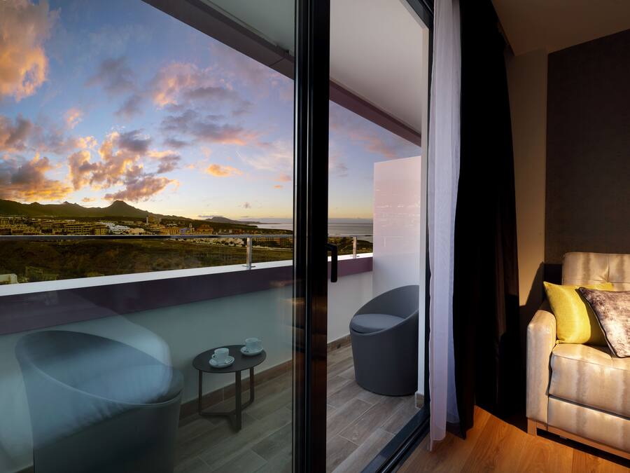 Una sala de estar moderna con un sofá, un sillón y una mesita.