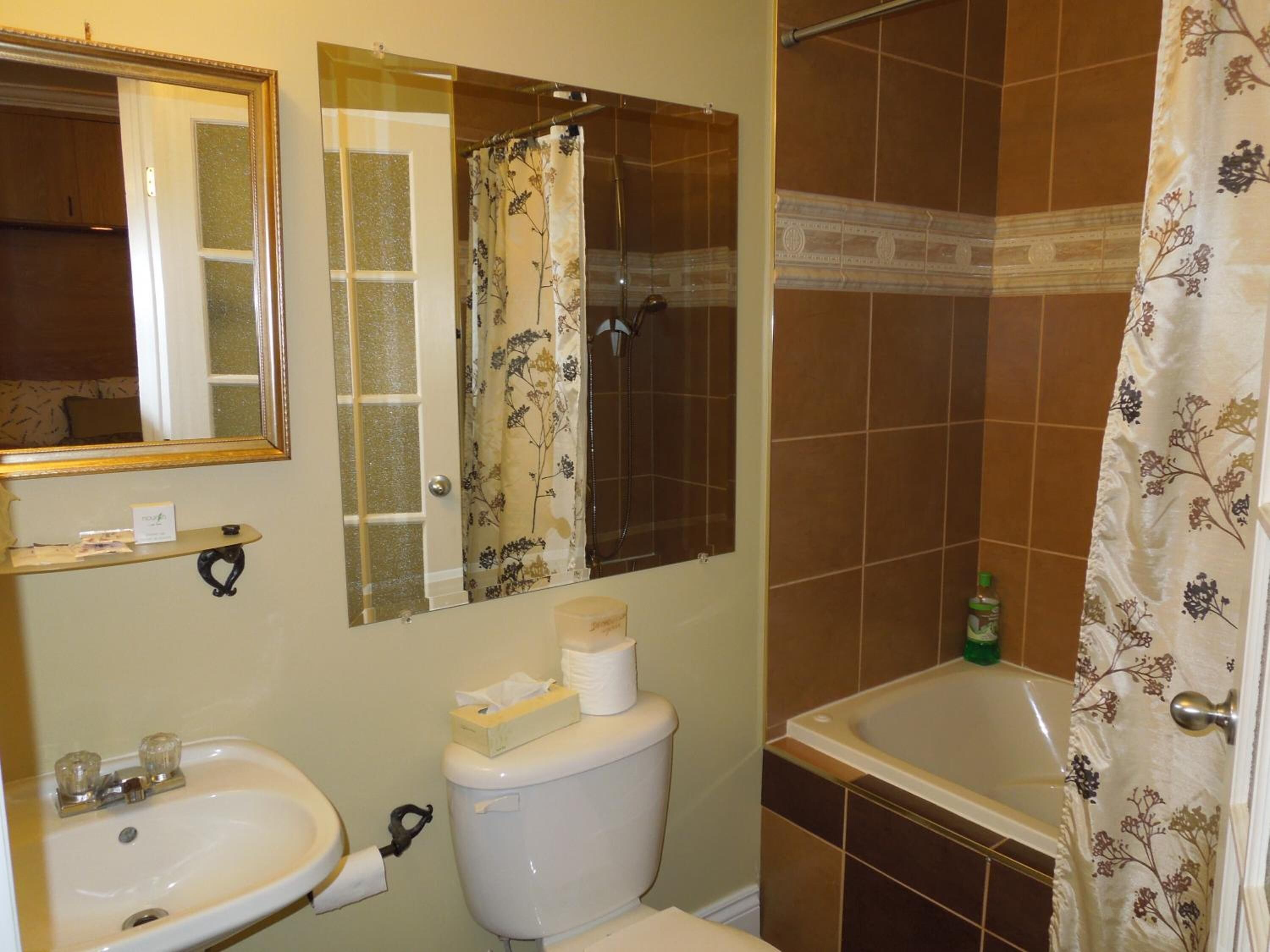 A bathroom with a sink, toilet, and bathtub.