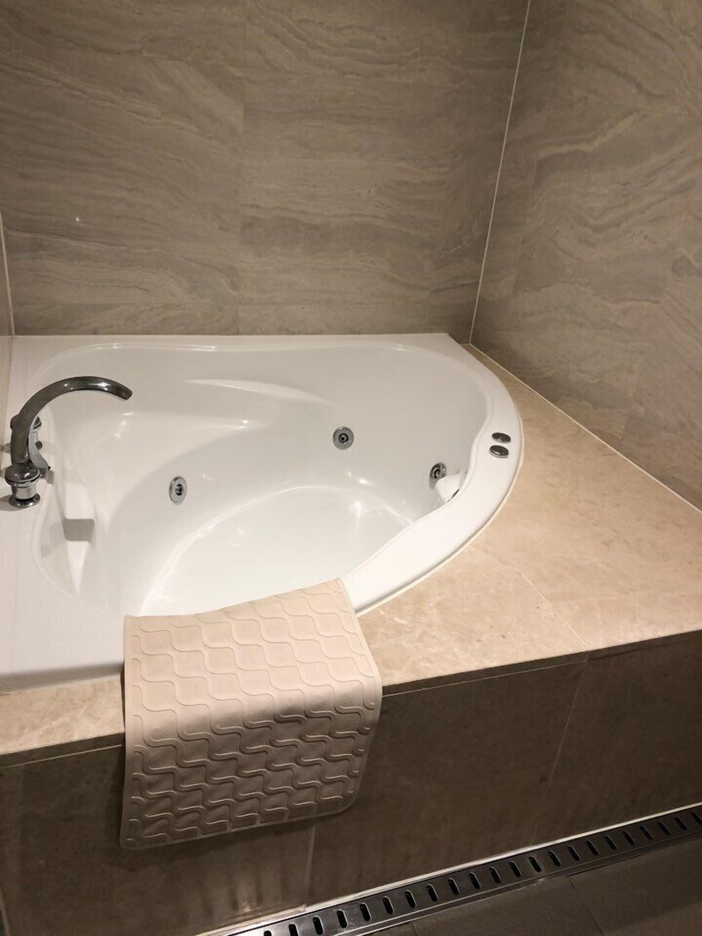 suite, 1 king bed, non smoking, jetted tub | bathroom | hair dryer, bathrobes, slippers, bidet