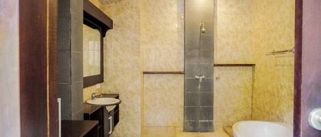 A modern bathroom with a bathtub, a sink, and a shower.