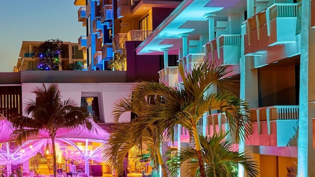 A hotel with a pool area, lounge chairs, and palm trees. - Loligo Resort Hua Hin (Hua Hin)