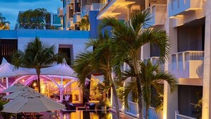 A hotel with a pool area, lounge chairs, and palm trees. - Loligo Resort Hua Hin (Hua Hin)