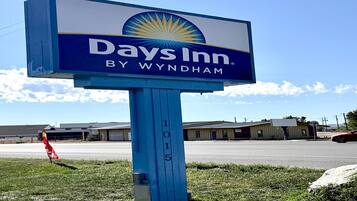 Days Inn -kyltti, jossa on aurinkokuva ja teksti ”Days Inn by Wyndham” sinisellä pohjalla.