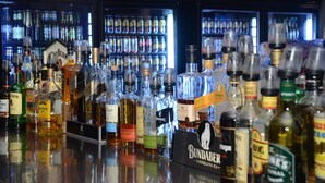A bar with various bottles of alcohol, including Bundaberg and other brands, displayed on shelves and the counter. - Capricorn Hotel (Blackwater)