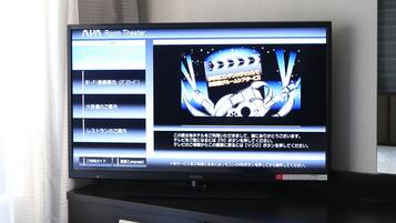 A television displaying a menu for an APAC Room Theater service.