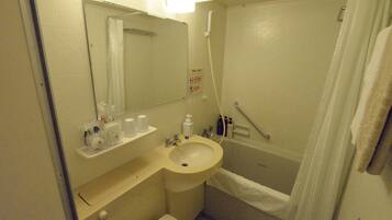 A small bathroom with a sink, mirror, and shower.