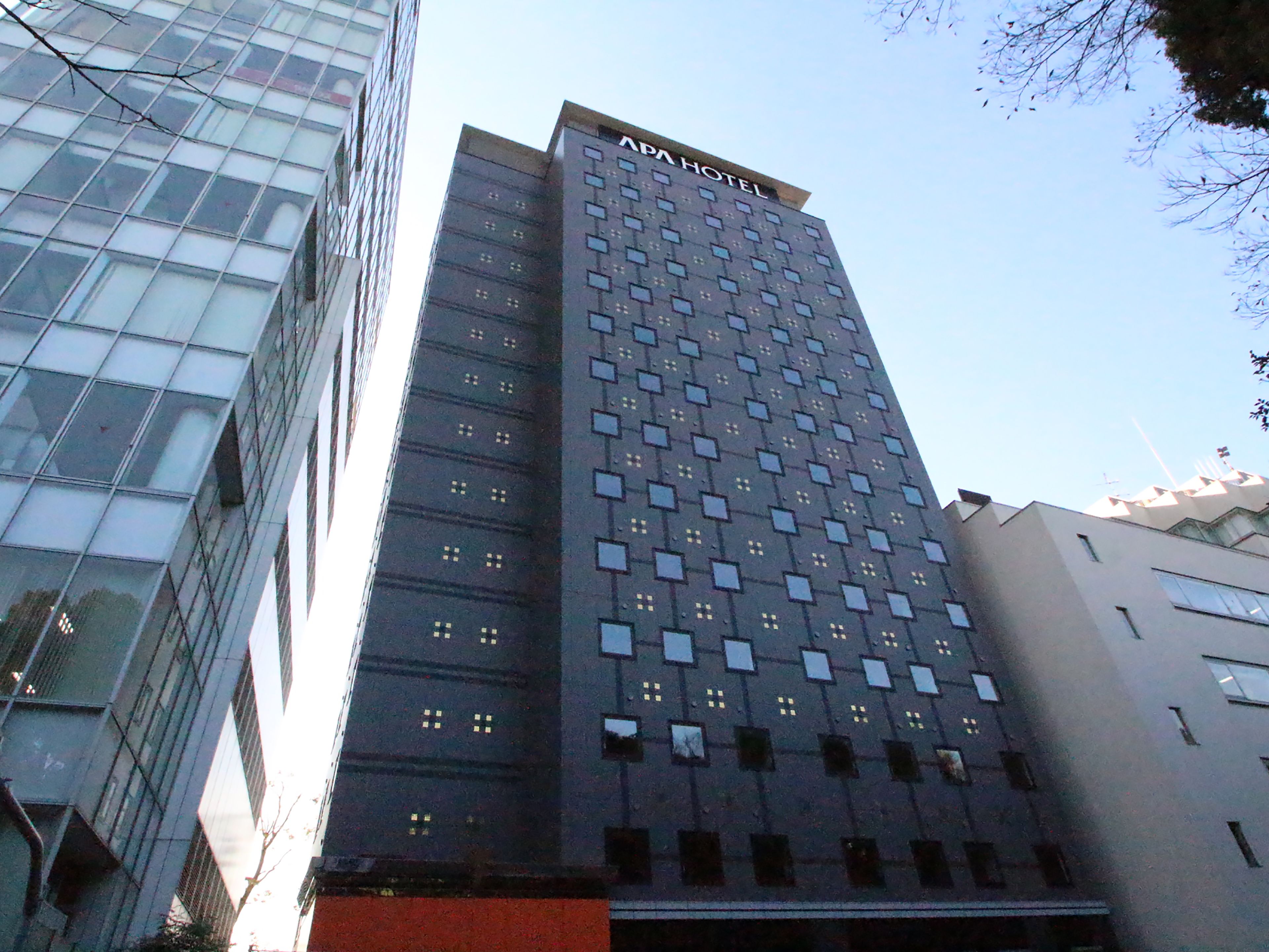 A tall building with a grid of windows and a sign reading "NAPA HOTEL".