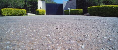 A paved driveway leading to a building with a sign that reads "Willow."