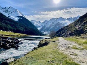A mountainous landscape with a river, a clear sky, and snow-capped peaks. - Hotel Saint Georges Lourdes Pyrenees (Lourdes)