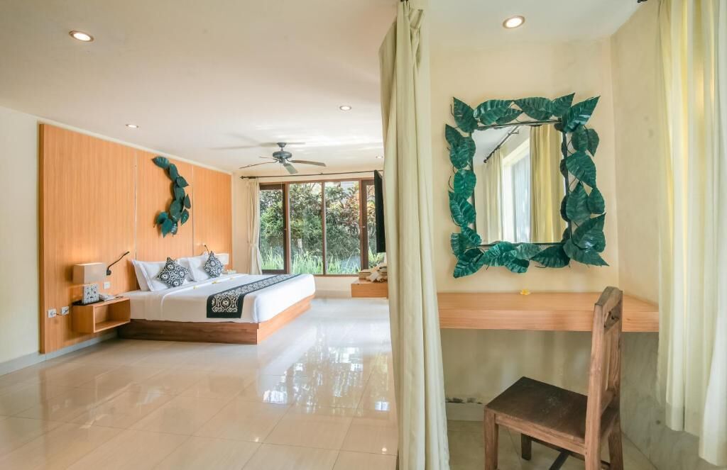 A modern bedroom with a bed, bedside tables, a wooden wardrobe, a ceiling fan, and a large window with curtains.