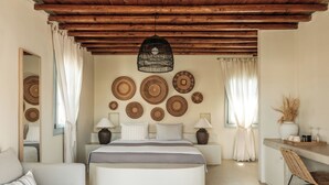 A bedroom with a bed, bedside tables, a chair, a desk, and a mirror. - Verina Terra (Sifnos)