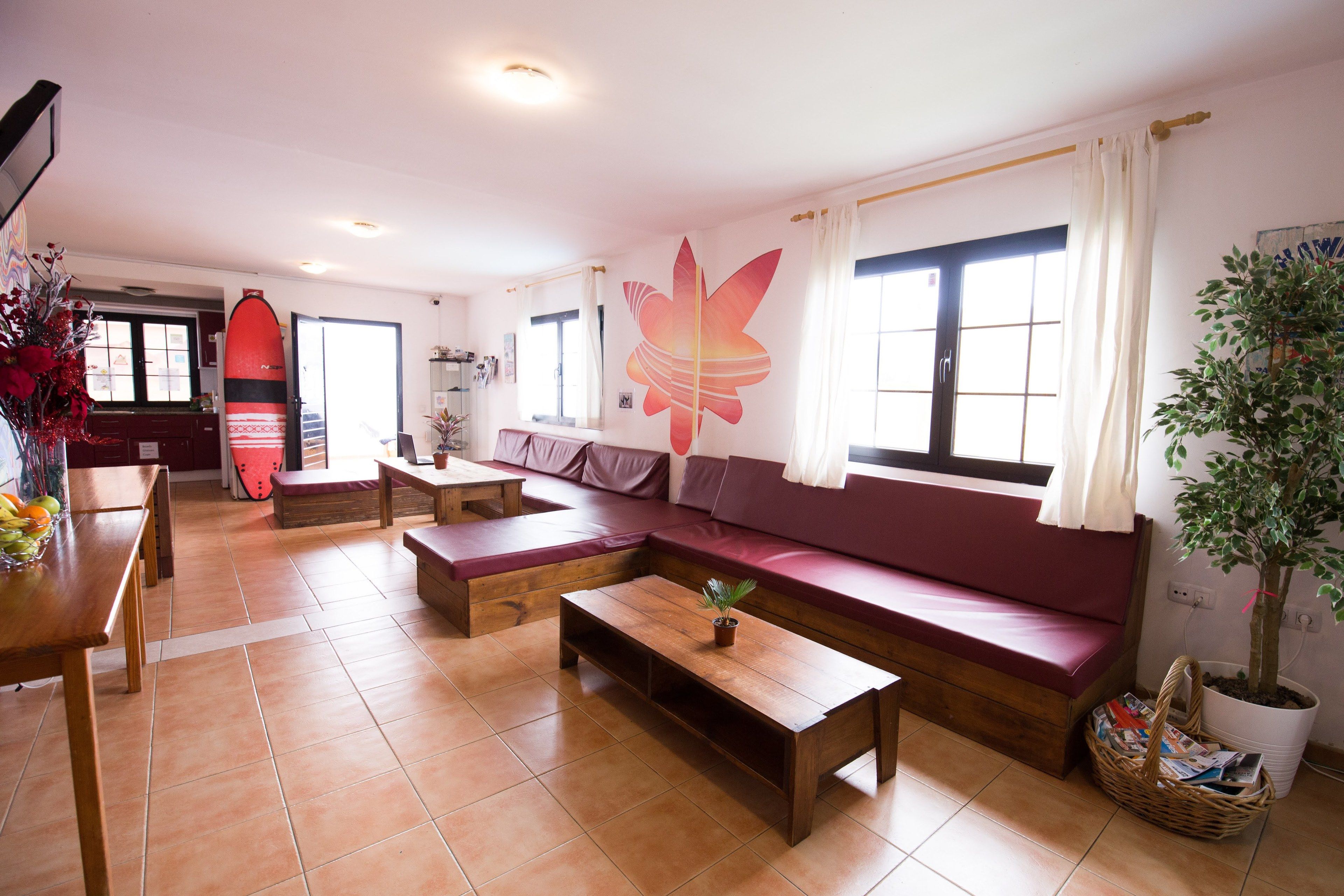 A living room with a sofa, a coffee table, and a dining area with a bench.