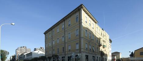 A multi-story building with a classic architectural style, featuring a symmetrical facade and a central entrance.