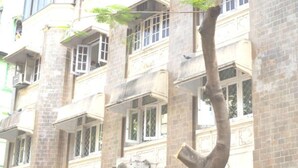 A multi-story building with a traditional architectural style, featuring large windows and balconies. - Bentleys Hotel Colaba (Mumbai)