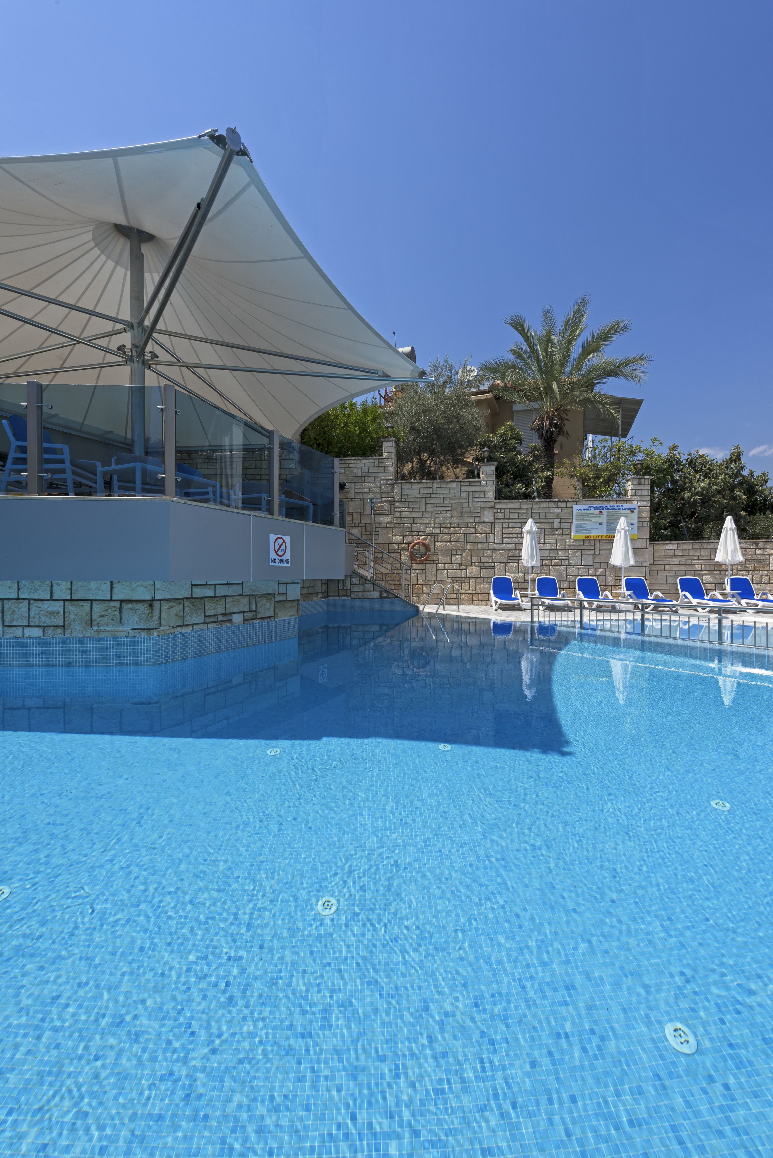 seasonal outdoor pool, pool umbrellas, pool loungers