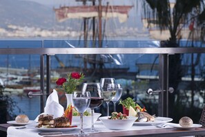 Dine with a view of the marina, surrounded by a selection of dishes and fine wine.