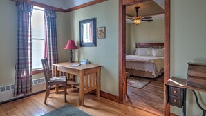 A room with a wooden desk, chair, and bed. - Country Encounters (Coleman)
