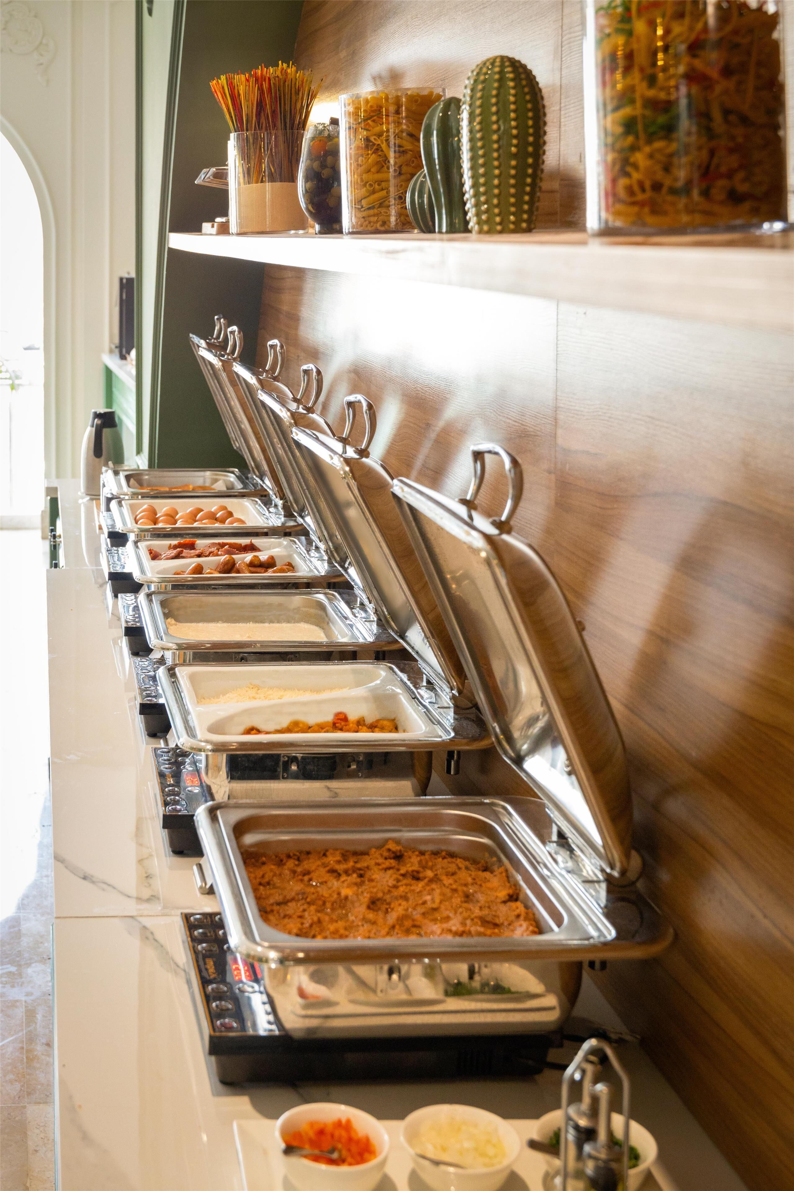 A buffet setup with multiple food stations and a variety of dishes.