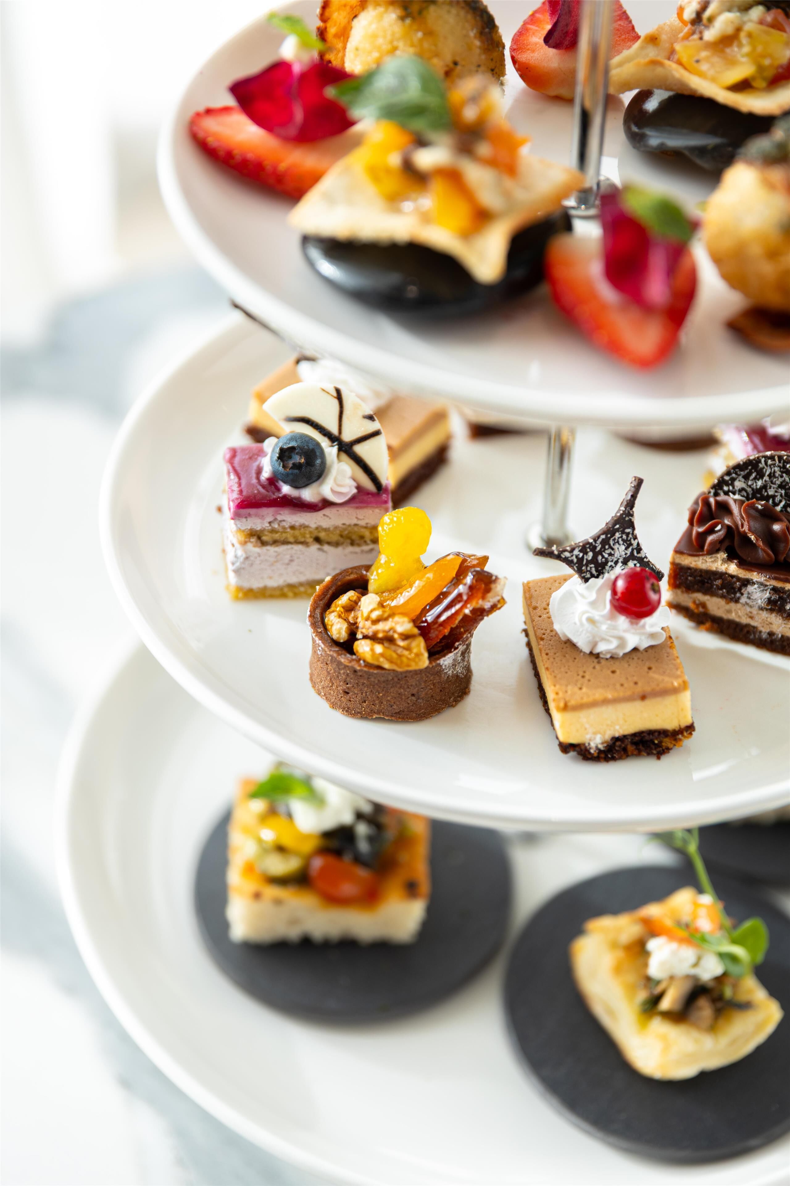 Eine mehrstufige Dessertvitrine mit verschiedenen Gebäcken und Desserts.