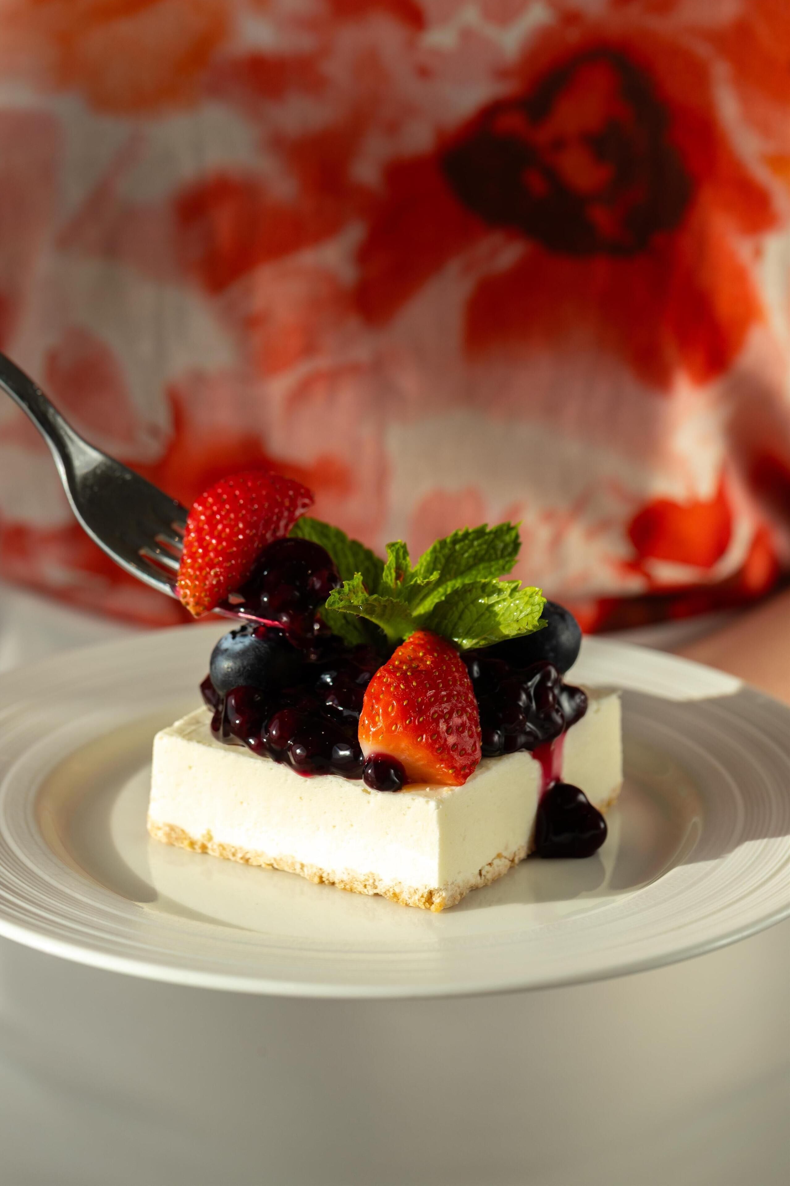 A dessert with strawberries and blueberries on a white plate.
