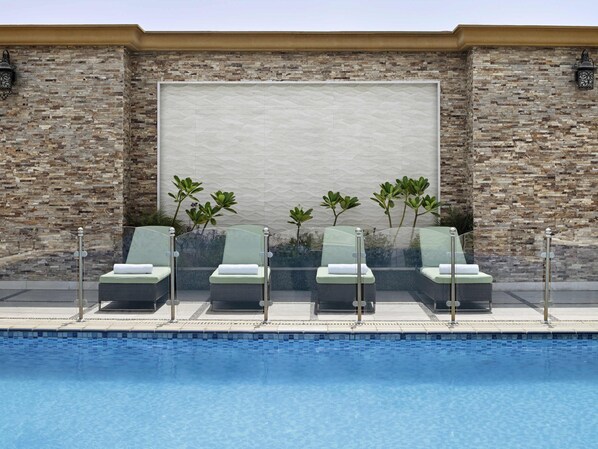 Outdoor pool, open 6:00 AM to 5:00 PM, pool umbrellas, pool loungers