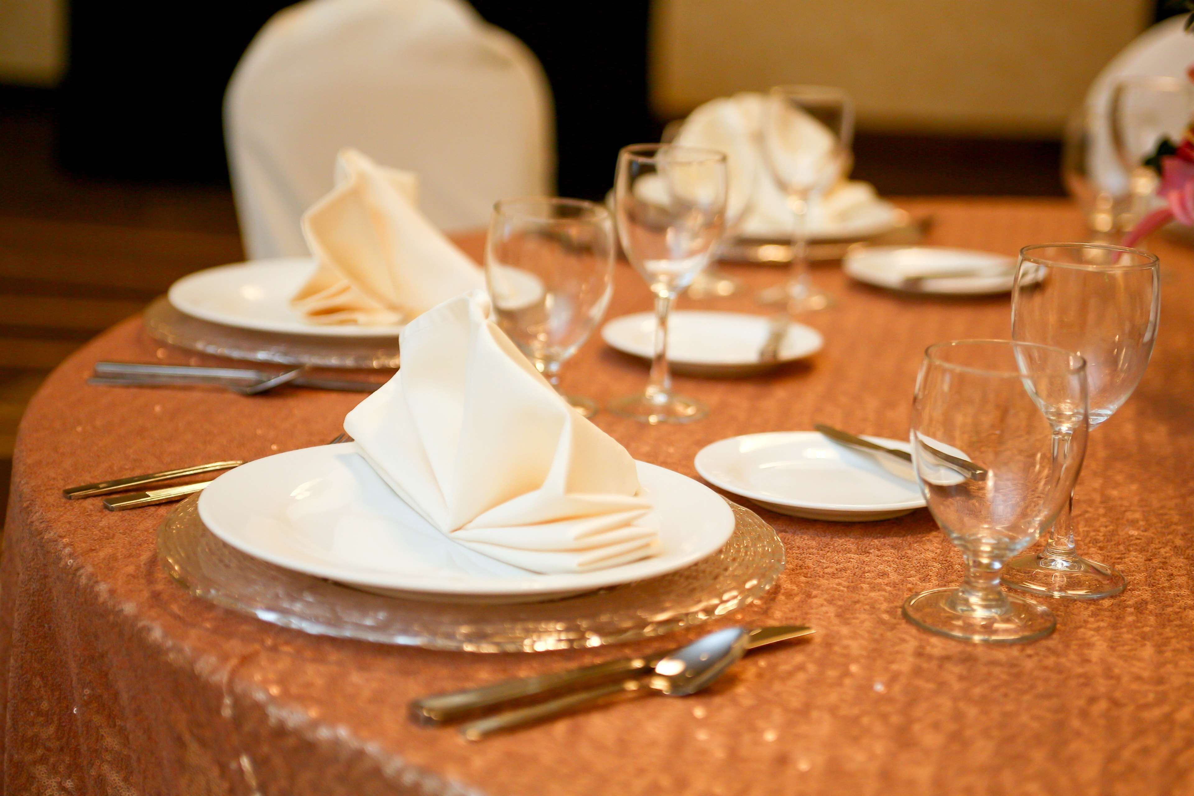 A table set for dining with plates, glasses, and cutlery.