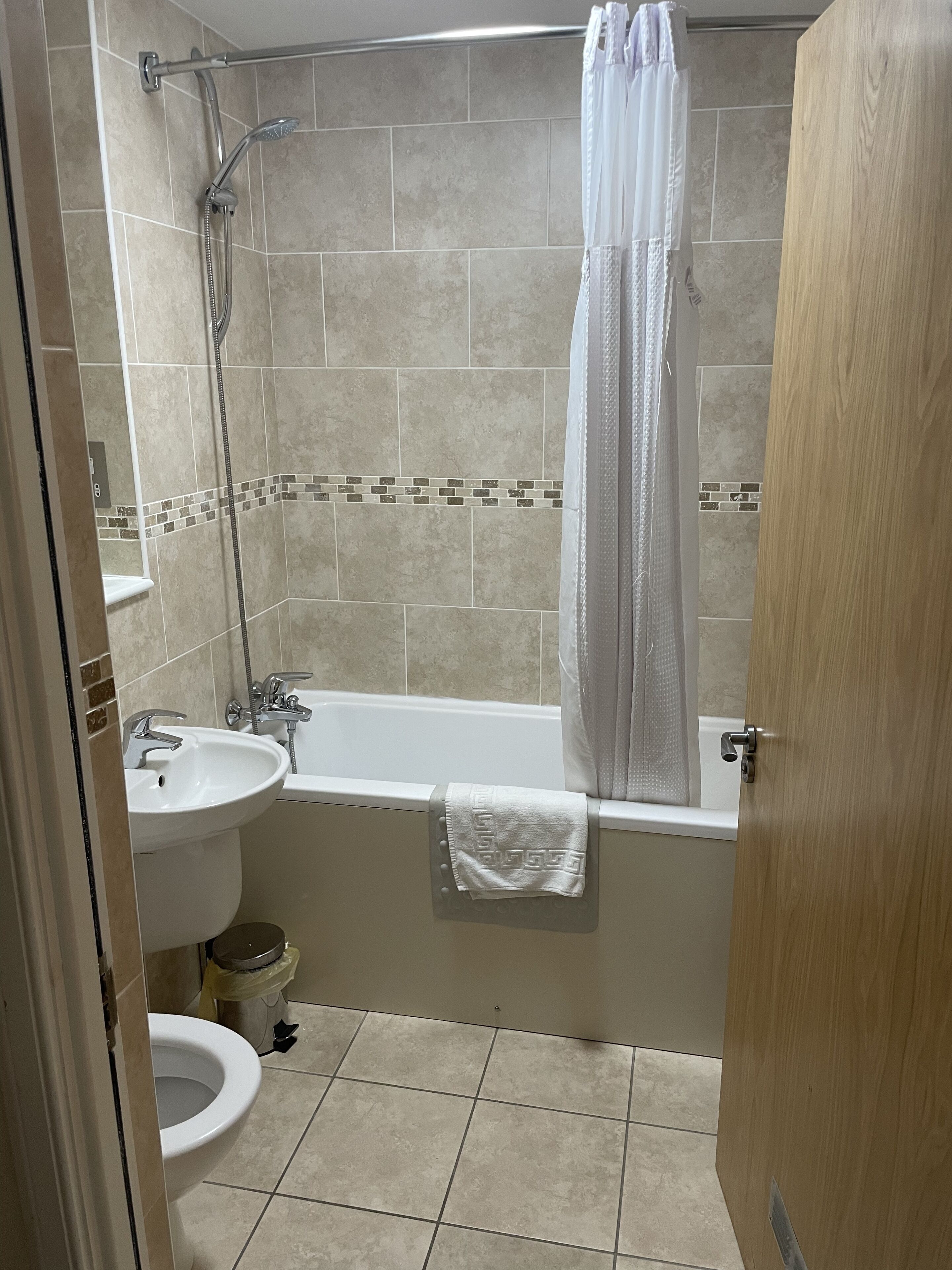 A bathroom with a bathtub, a sink, and a shower.