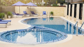 Outdoor pool, open 6:00 AM to 10:00 PM, pool umbrellas
